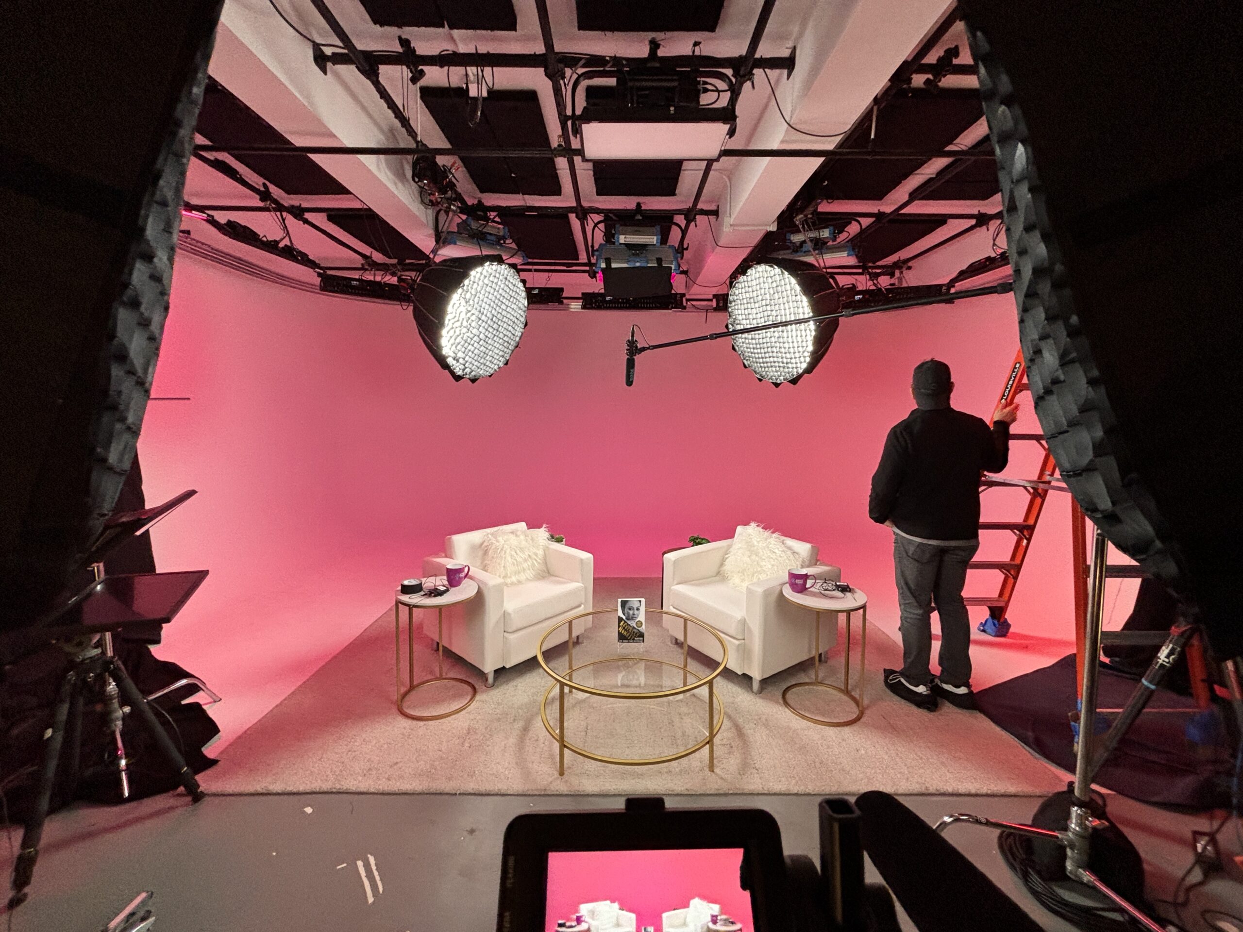 pink set with white chairs at ASL studios with custom lighting