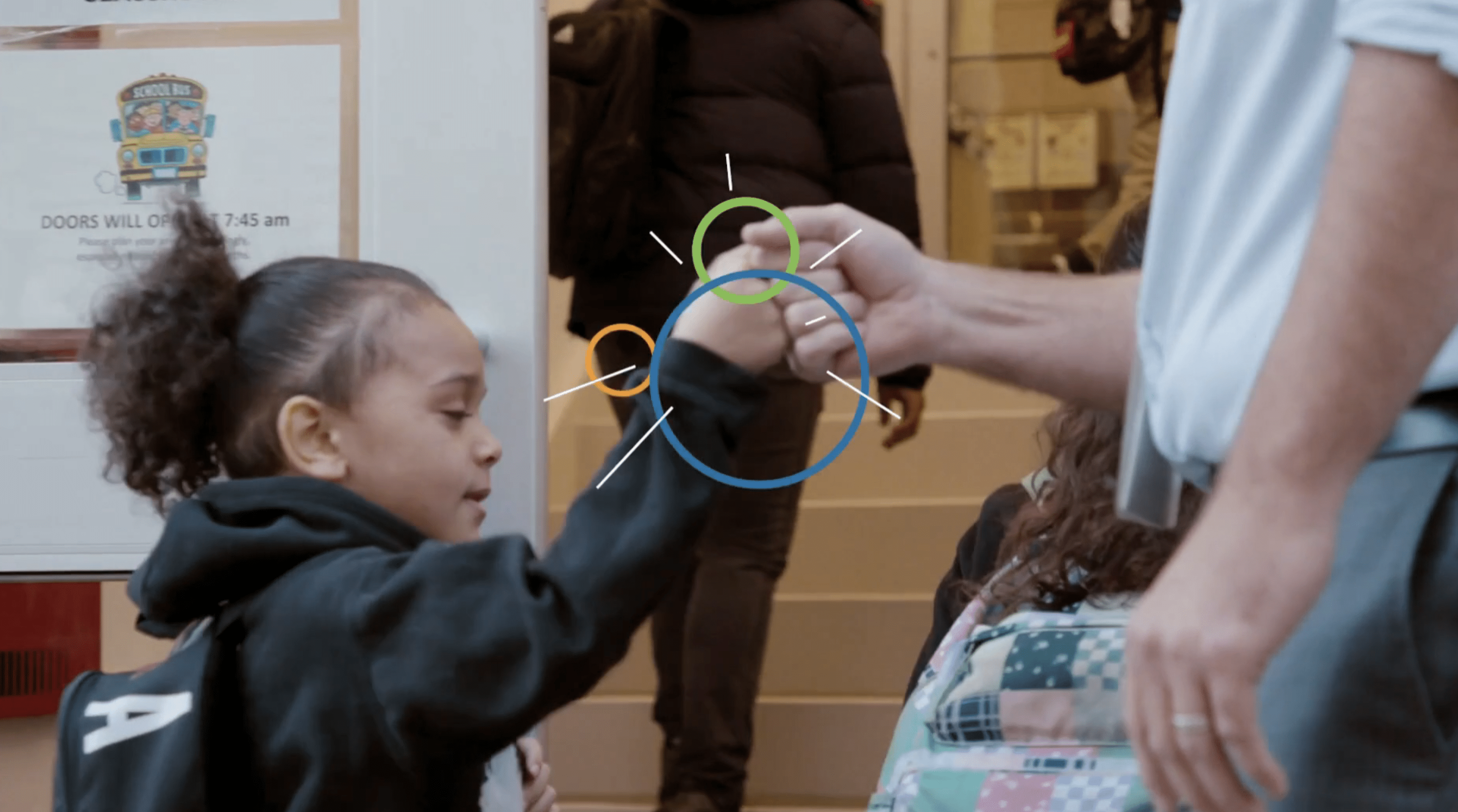 Student at Haven School in NYC fist bumping a teacher as she walks into school.