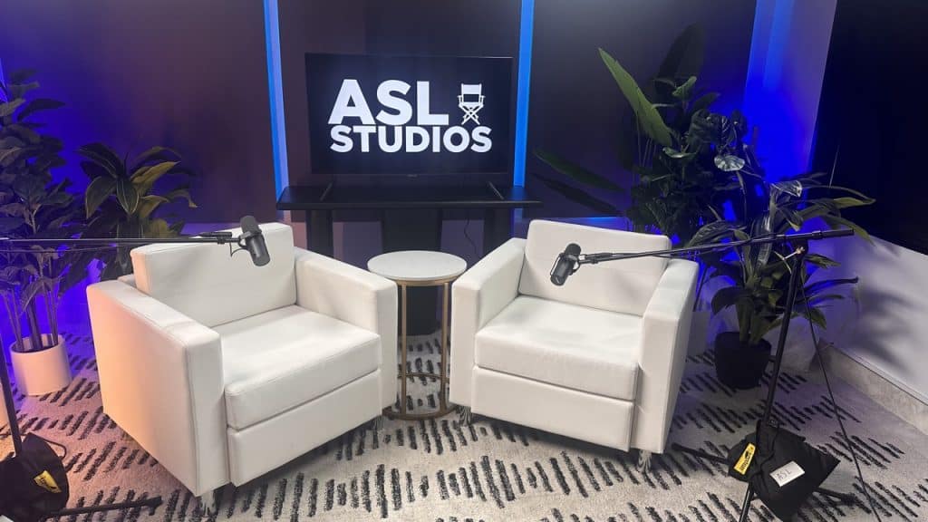 bts video podcast studio nyc at asl studios with white chairs and neon lighting