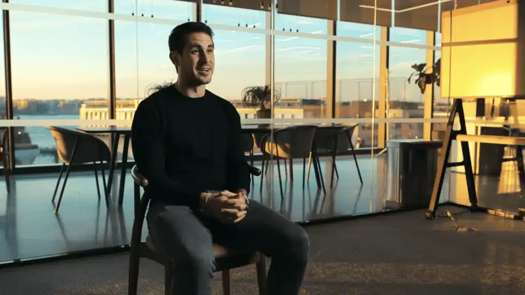 GE Healthcare Testimonial for Checkout.com. subject sitting in interview in front of window for corporate video production